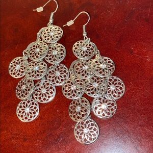 Dangly silver colored earrings with rhinestone
